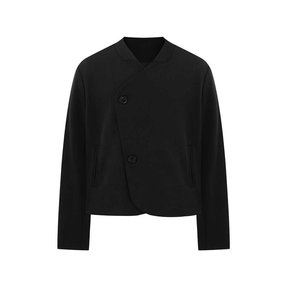 Black cropped collarless jacket with asymmetric curved front, two buttons and hip welt pockets, flat front view