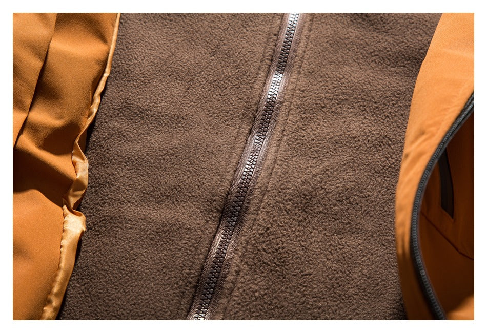 Close-up of the brown fleece lining and zipper between the orange jacket panels.
