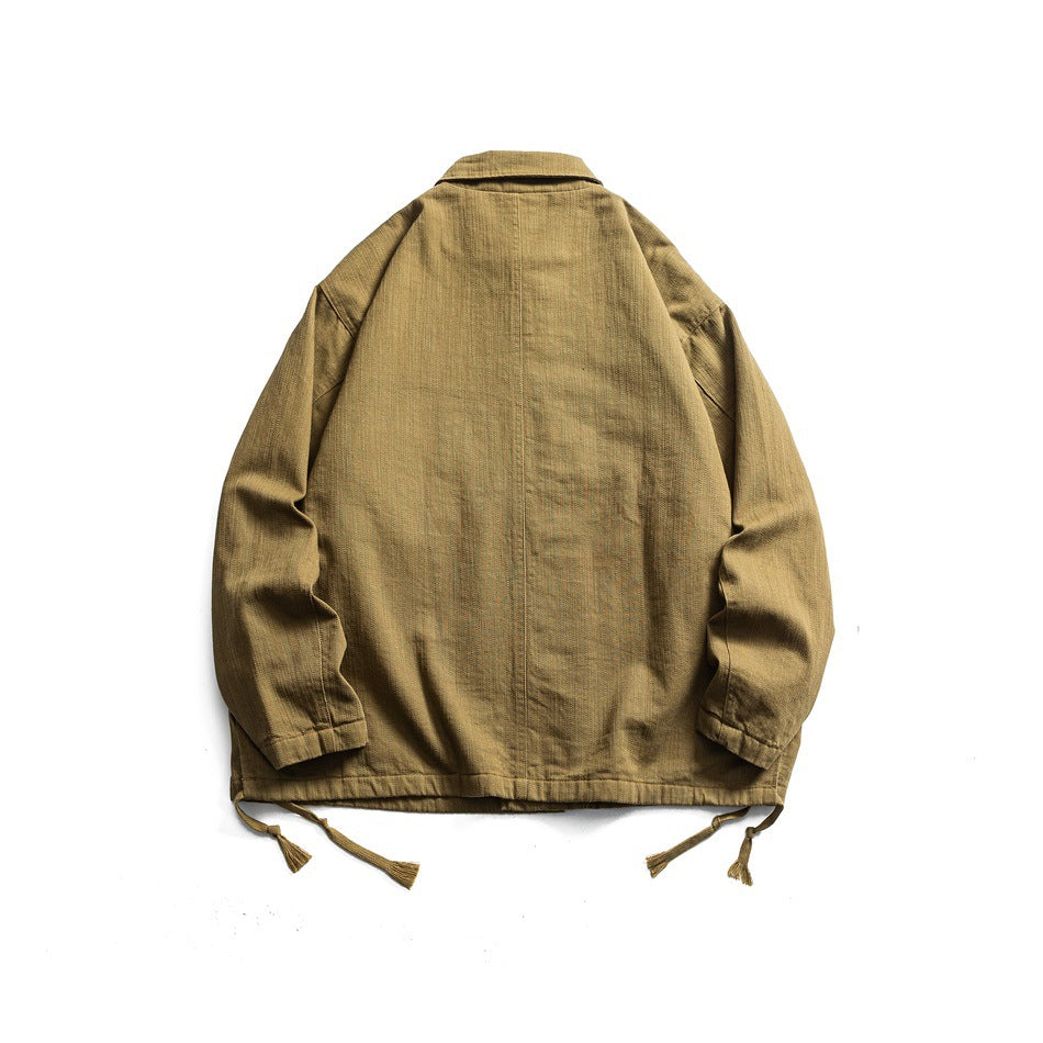 Back view of an olive-khaki collared jacket with long sleeves and dangling hem ties, laid flat.