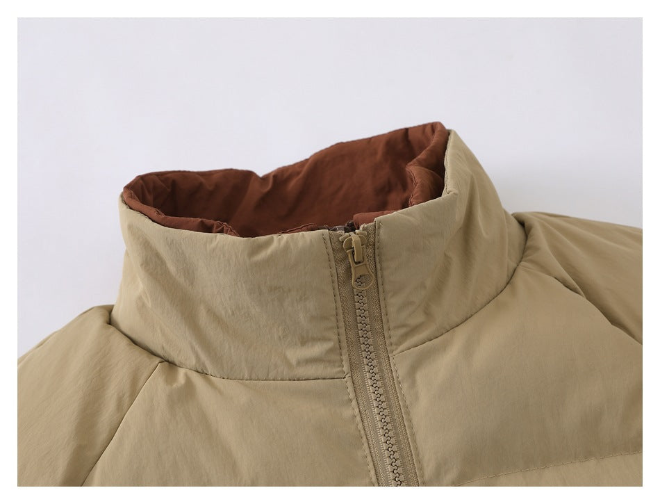 Close-up of the beige jacket's high collar, brown lining, and front zipper.