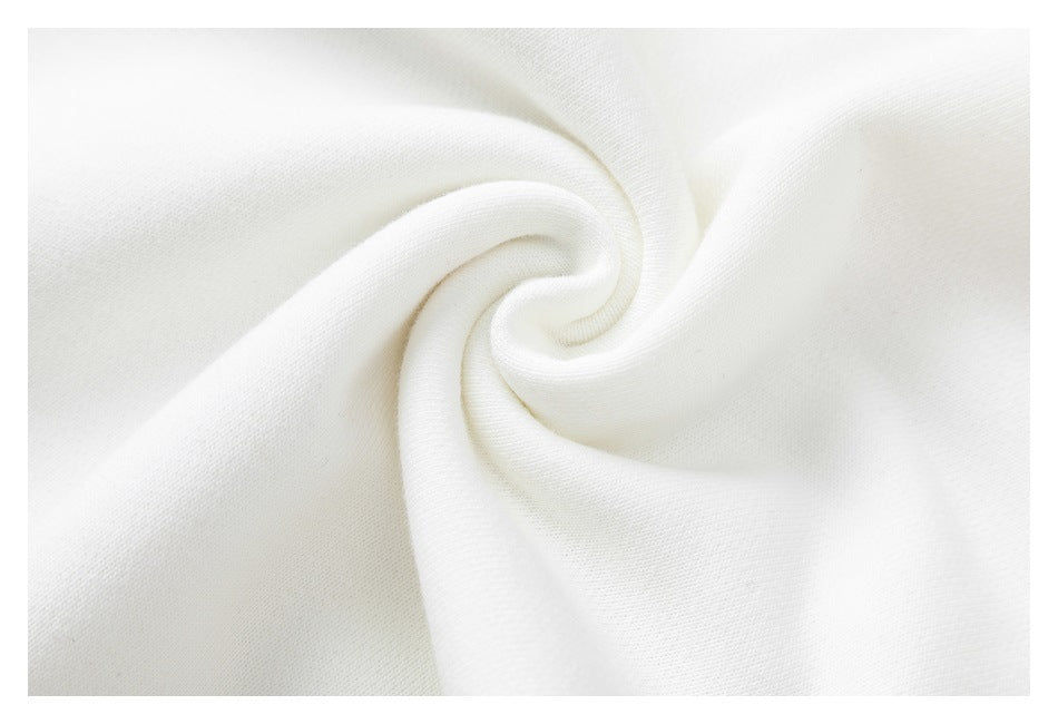 Close-up of soft-looking white sweatshirt fabric gathered into a swirl.