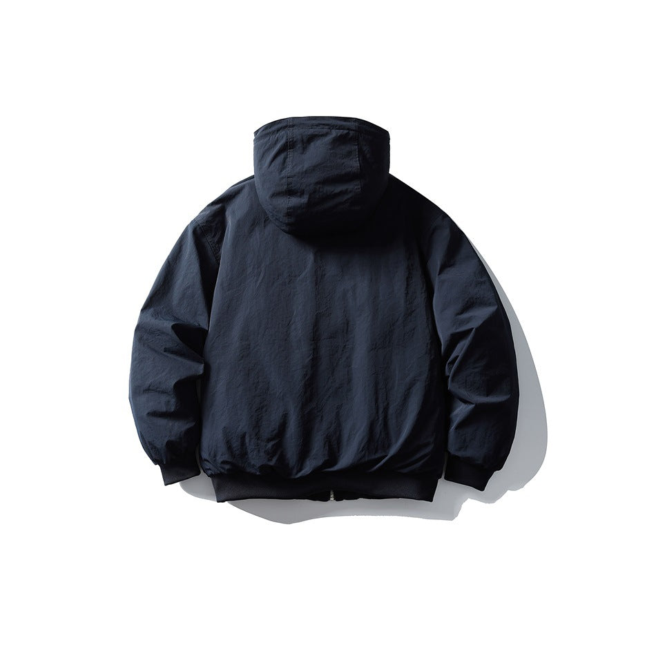 Back view of navy blue hooded puffer jacket showing stitched hood, ribbed cuffs and ribbed hem