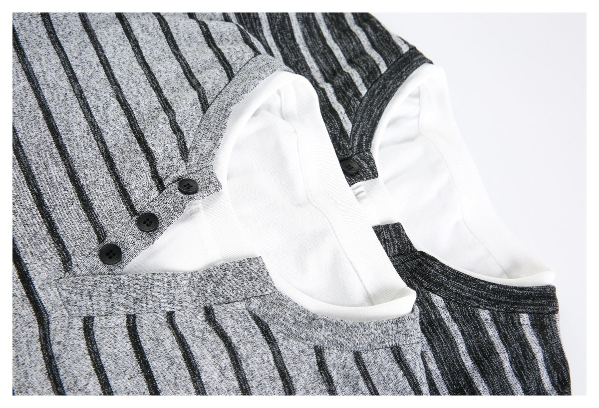 Close-up of two striped tops in gray and charcoal, showing white neck trim and button details.