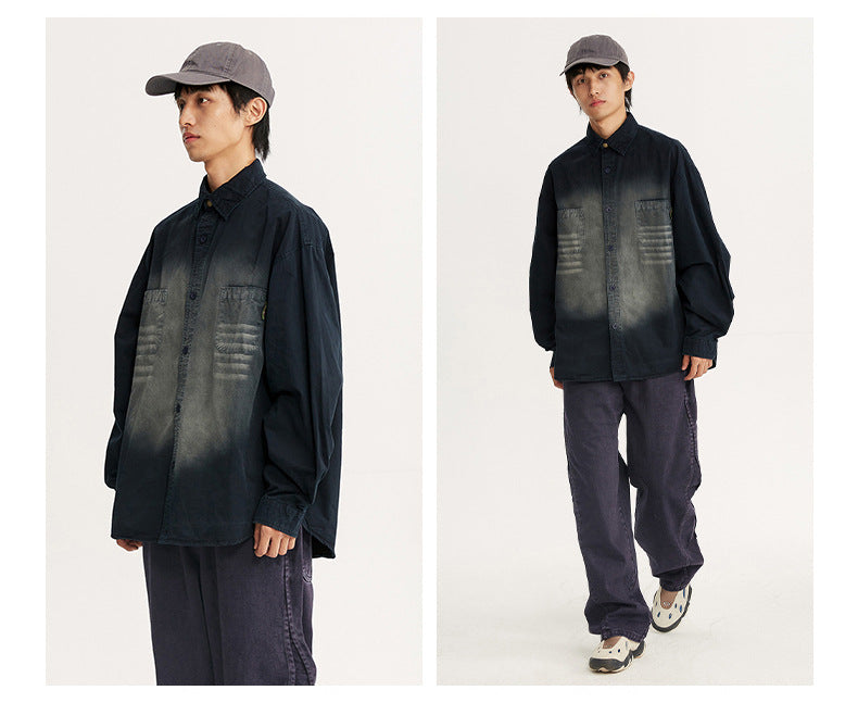 Two views of a model wearing an oversized black shirt with a faded gray chest and two patch pockets.