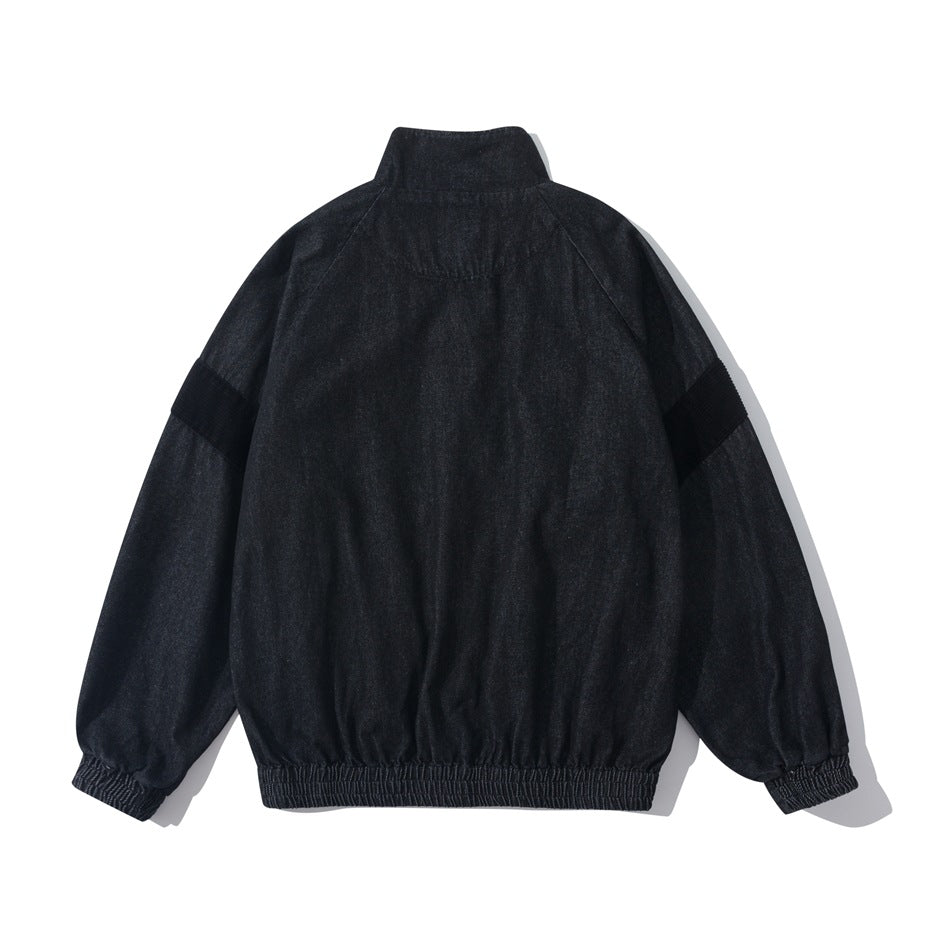 Back view of black denim-look jacket with stand collar, raglan sleeves, black sleeve bands, elastic cuffs and hem