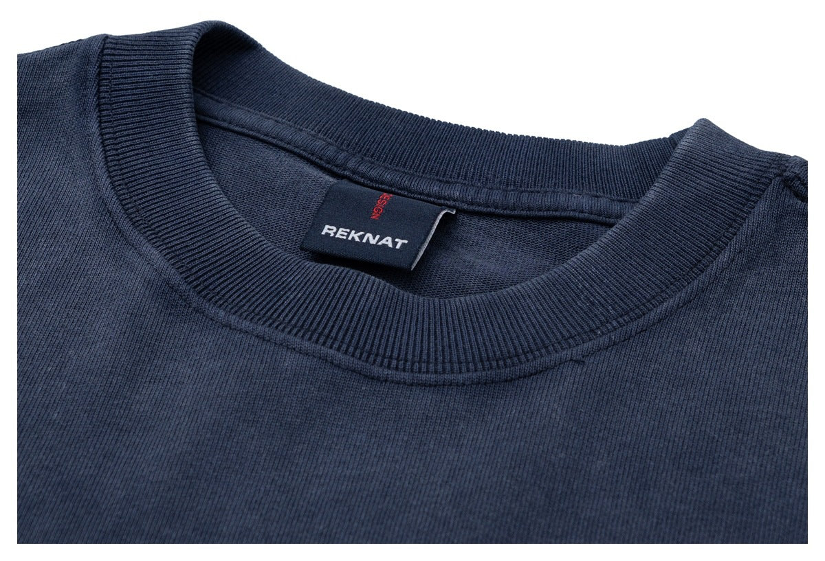 Close-up of the navy T-shirt's ribbed crew neck and inside neck label.