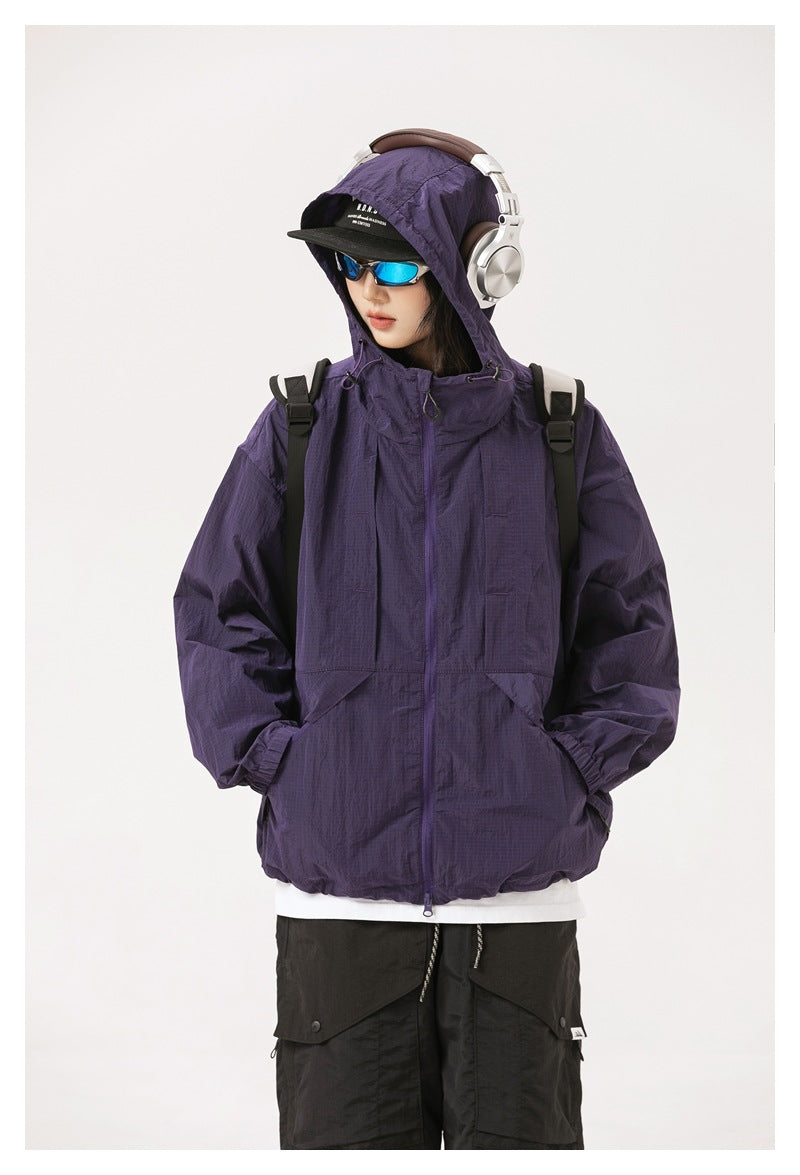 Front view of a model wearing a purple hooded zip jacket with front pockets.