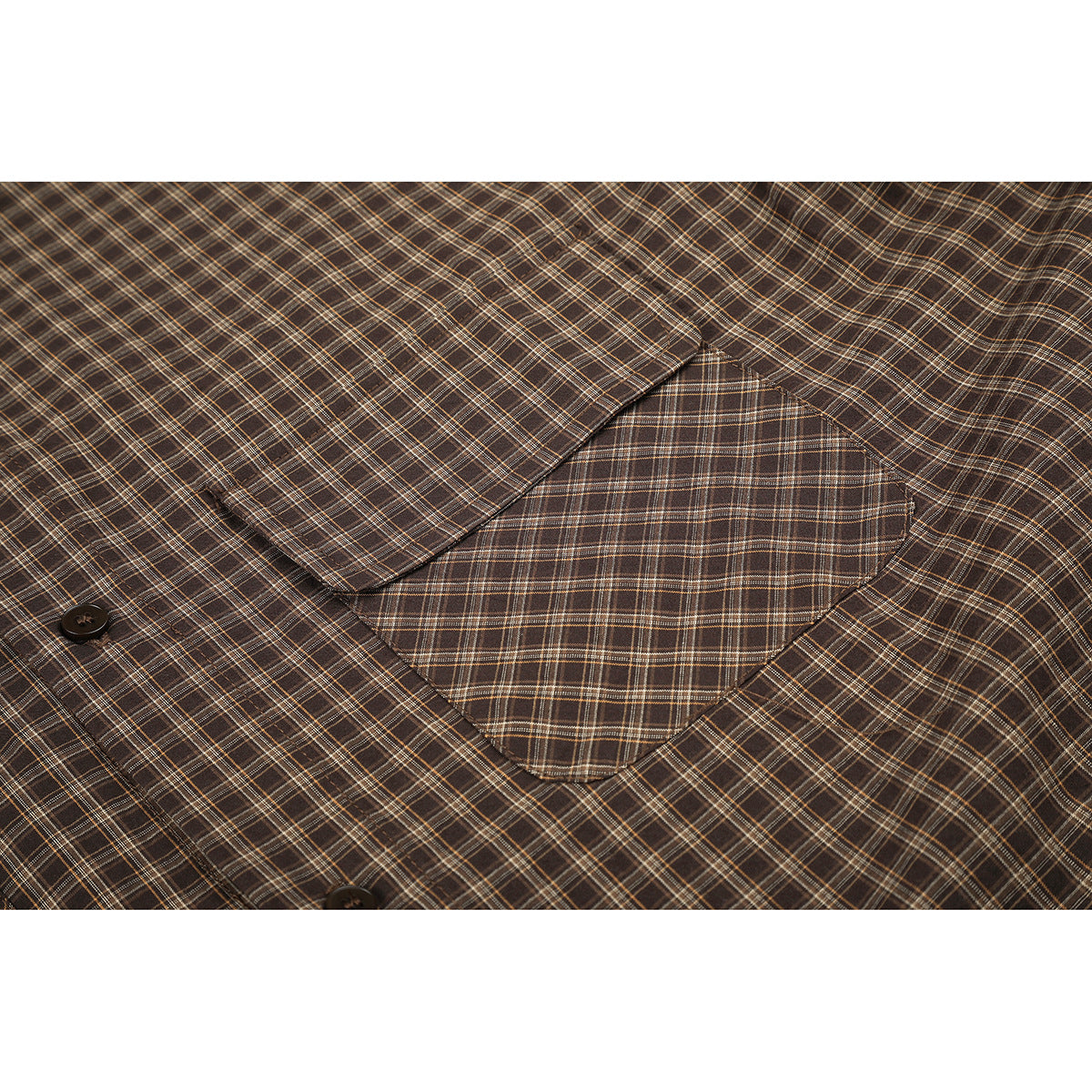 Close-up of a brown plaid shirt's button and large chest pocket.