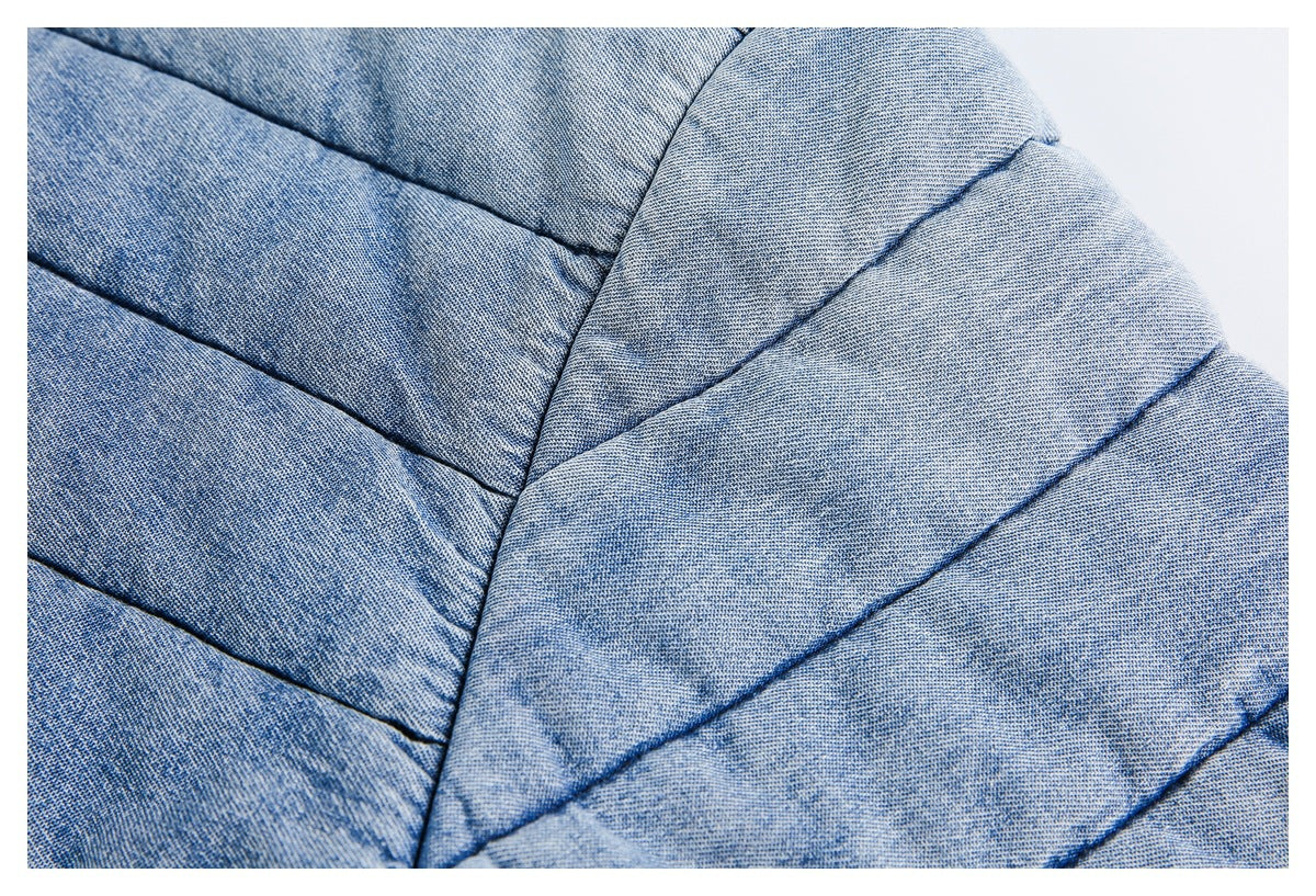Close-up showing the stitched quilting and light blue textured fabric of a jacket.
