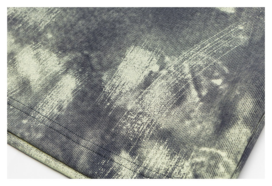 Close-up of a charcoal sweatshirt's pale distressed print and hem stitching.