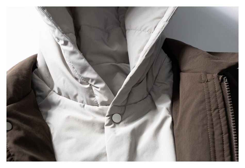 Close-up of the light gray padded hood lining, snap fastener, and zipper on a dark brown jacket.