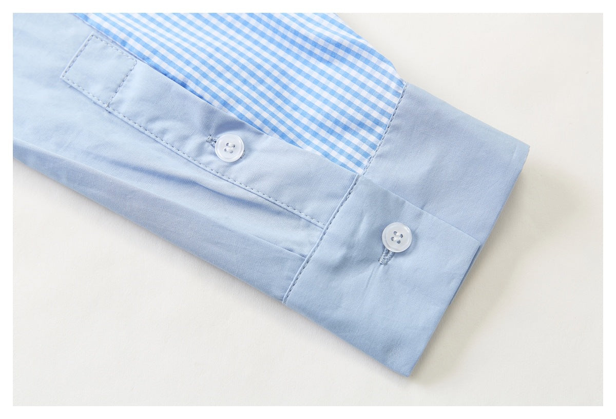 Close-up of a pale blue shirt cuff with white buttons and a blue-and-white gingham insert.