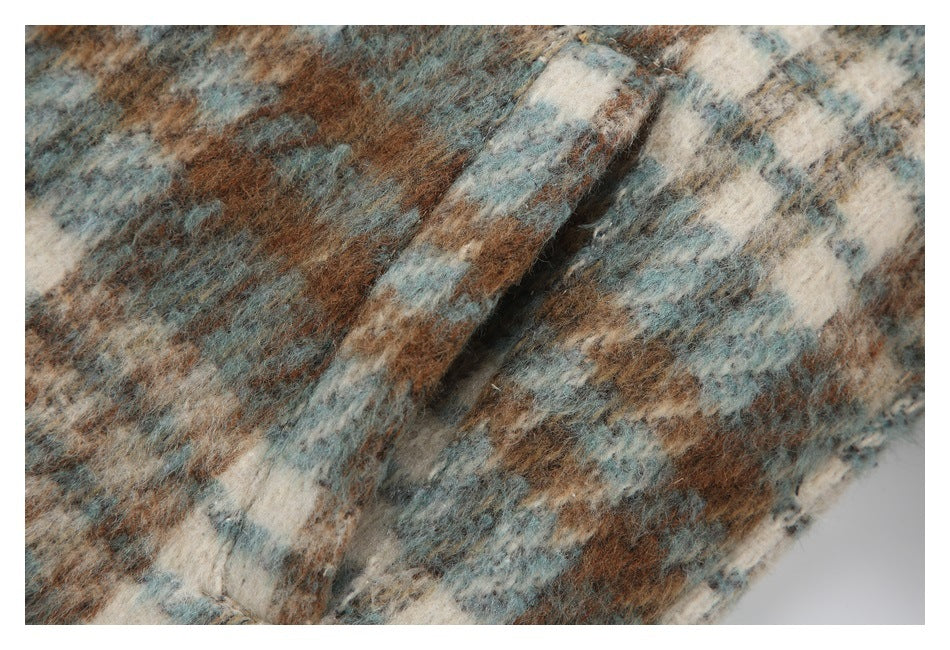 Close-up of a seam in the jacket's fuzzy multicolor checked fabric.