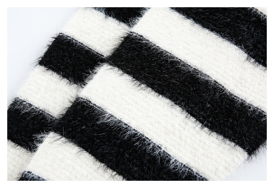 Close-up of a fuzzy black-and-ivory striped knit, showing the plush surface and stripe pattern.