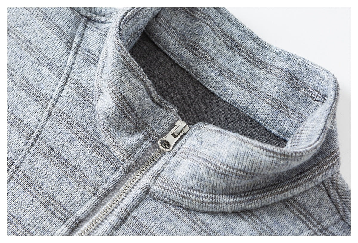 Close-up of a gray heathered knit garment's stand collar and silver front zipper.