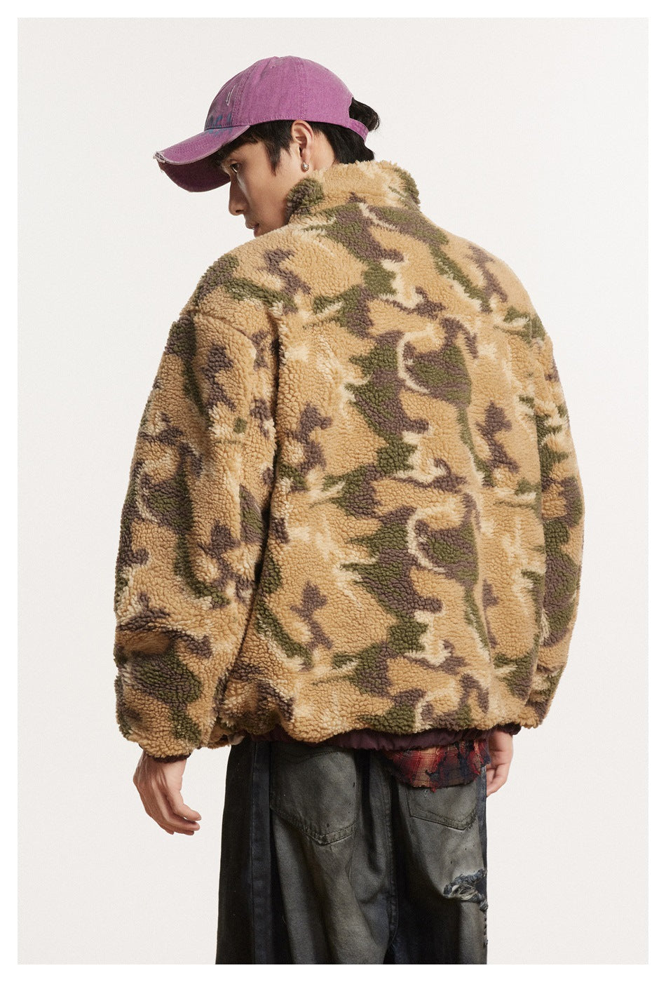 Back view of a model wearing a tan and olive camouflage fleece jacket with an elastic hem.
