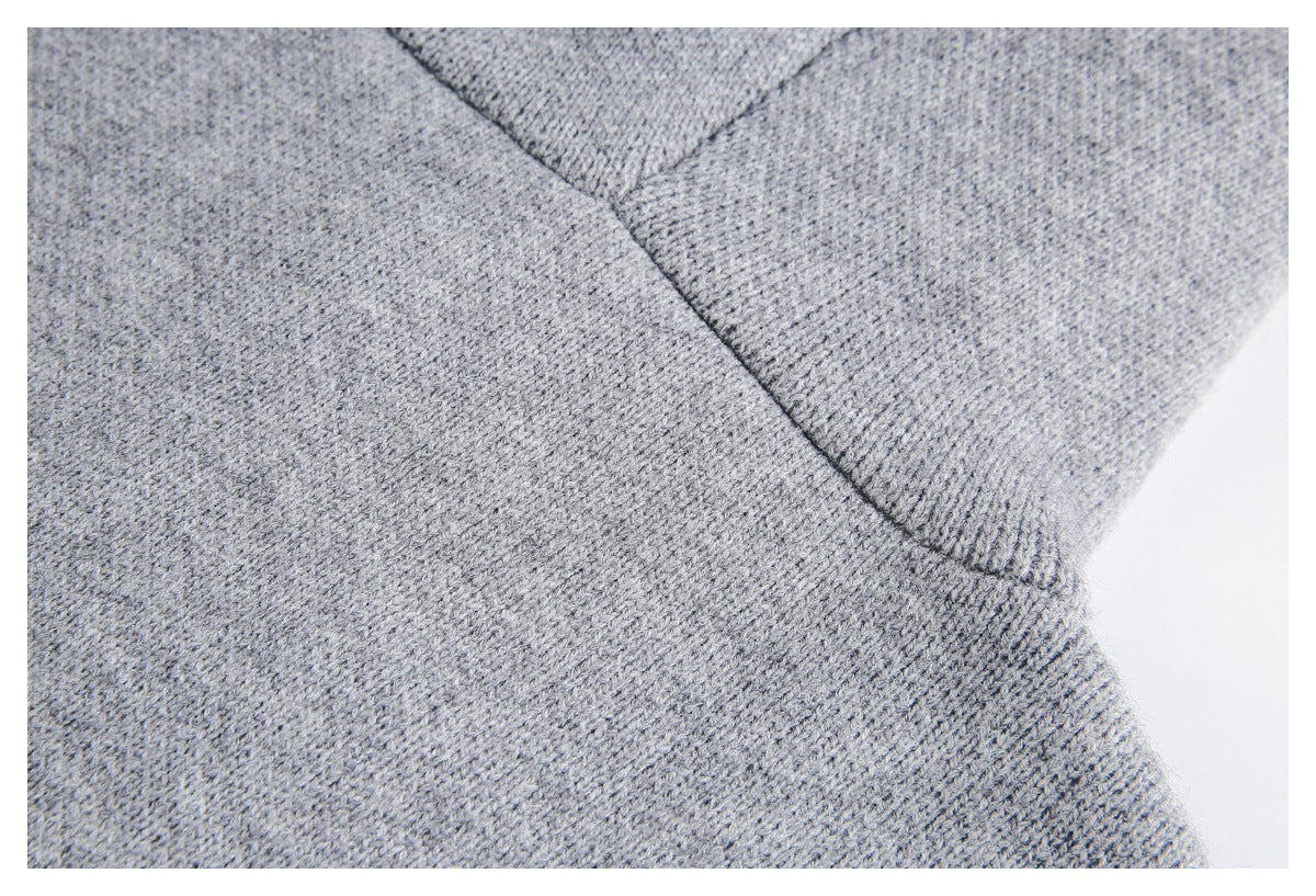 Close-up of a heather gray knit garment seam and ribbed edge.