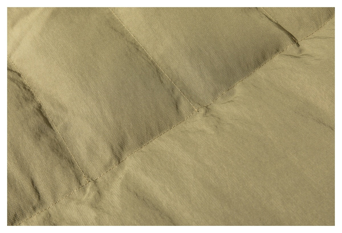 Close-up of olive fabric panels with diagonal stitched seams.