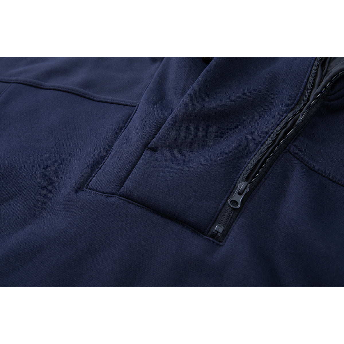 Close-up of the navy pullover's quarter-zip opening, zipper pull, and stitched front panel.
