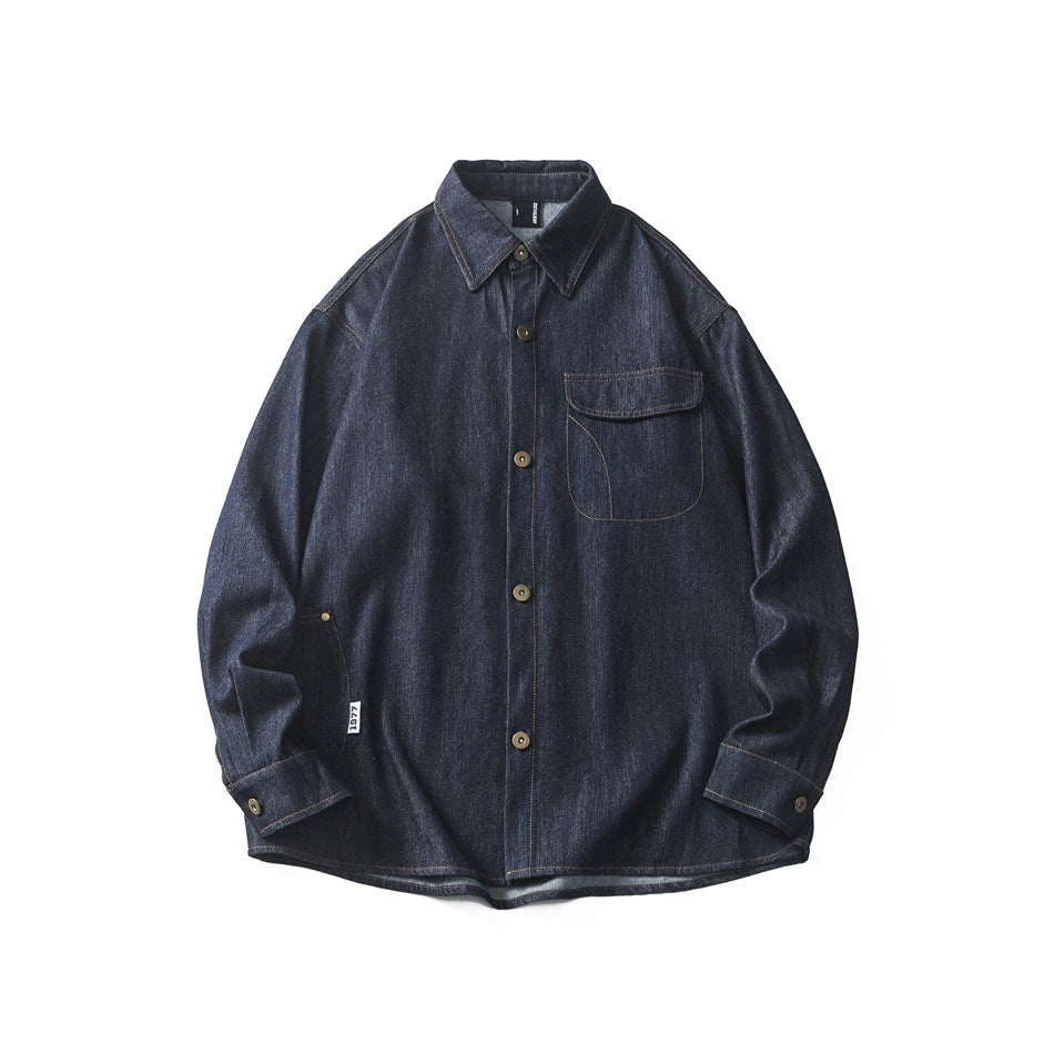 Dark indigo denim button-up shirt laid flat, with flap chest pocket and contrast topstitching