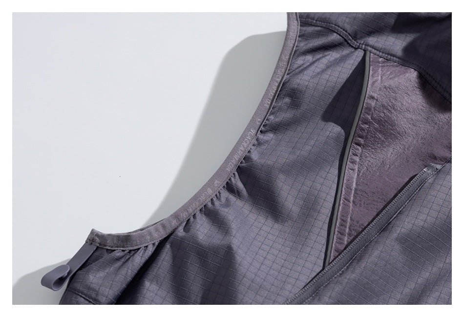 Close-up of a charcoal-gray grid-patterned jacket interior with a smooth lining and bound seam.