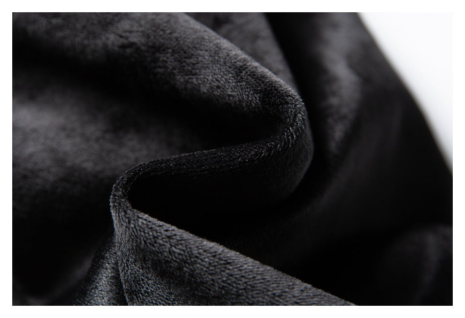 Close-up of dark charcoal fabric folded to show its soft, textured surface.