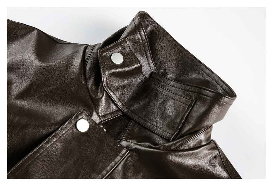 Close-up of a dark brown jacket collar with snap-button tabs and visible stitching.
