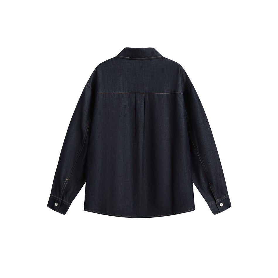 Back view of dark blue denim-look shirt showing yoke seam, center pleat and buttoned cuffs