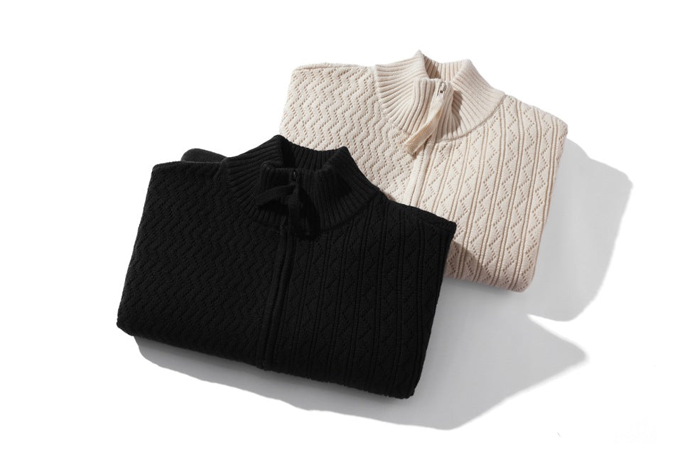 Folded textured knit zip cardigans in black and ivory, shown together.