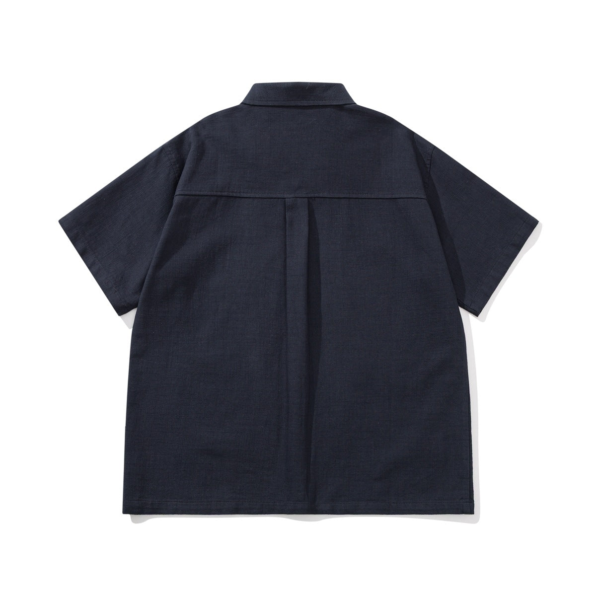 Back view of a navy short-sleeve shirt with a center pleat and a horizontal shoulder yoke.