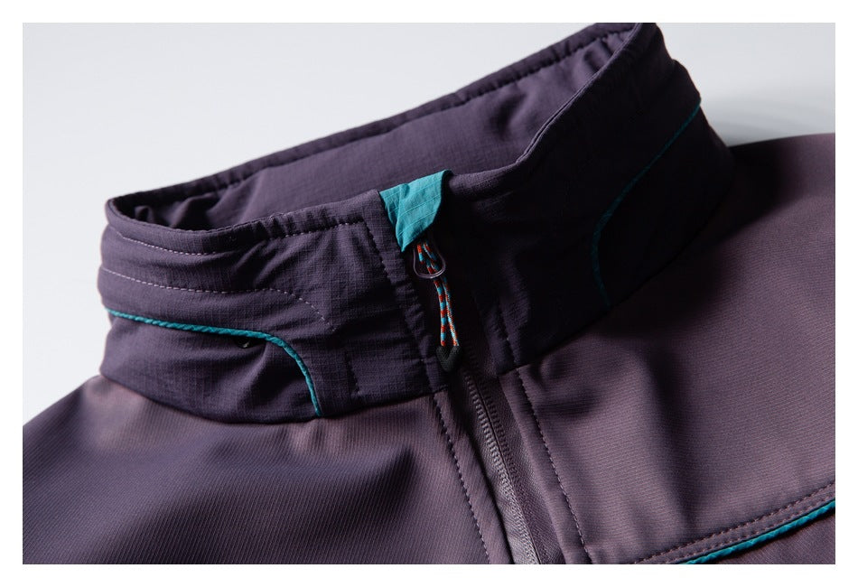 Close-up of the dark purple stand collar, teal trim, and front zipper pull.