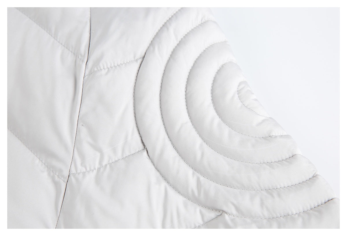Close-up of concentric curved quilting on the light gray puffer jacket's shoulder.