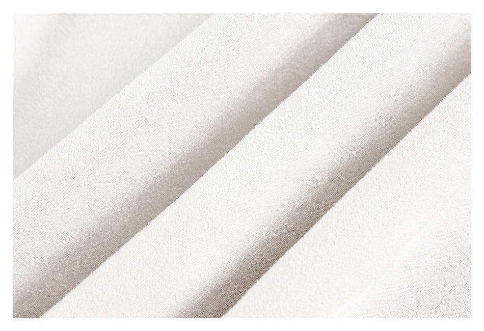 Close-up showing the soft-looking texture and folds of pale cream fabric.