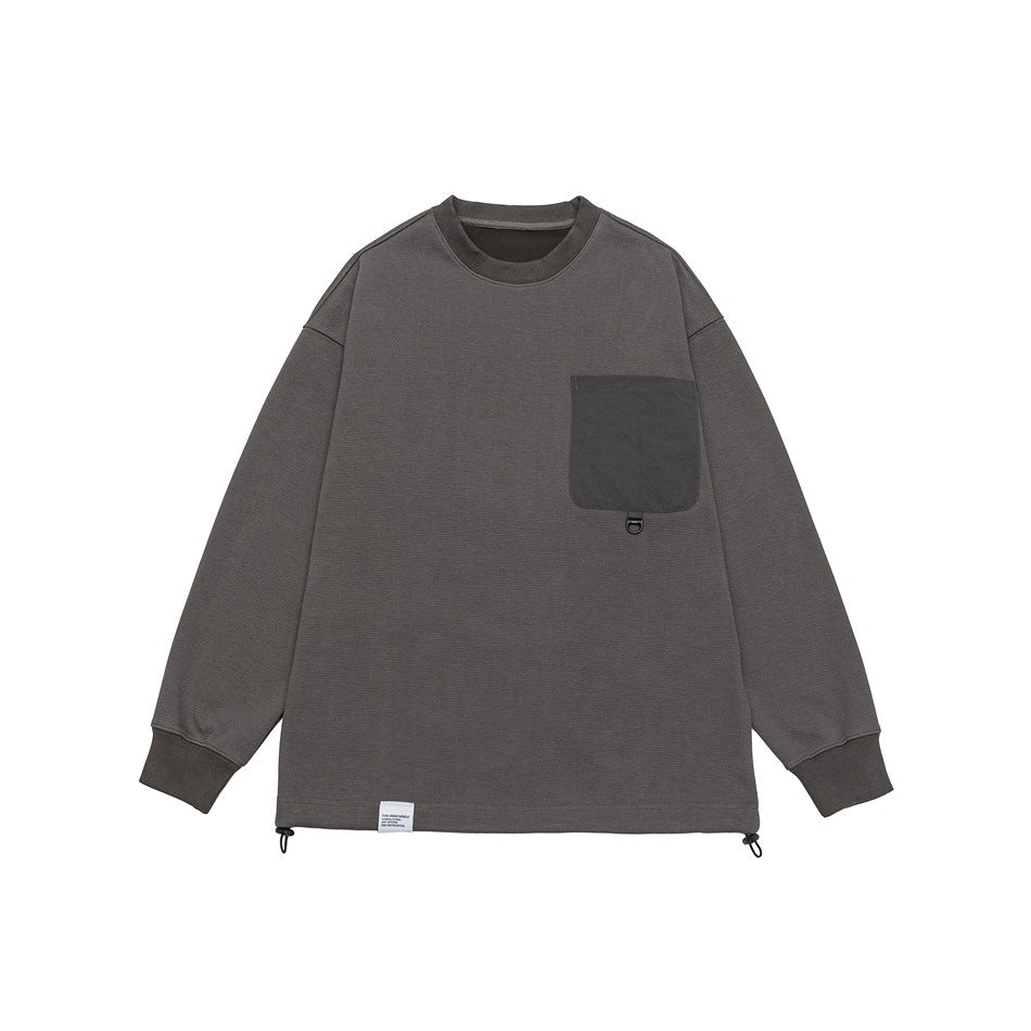 Dark gray crewneck sweatshirt flat lay with matching chest flap pocket, ribbed collar and cuffs, drawcord hem