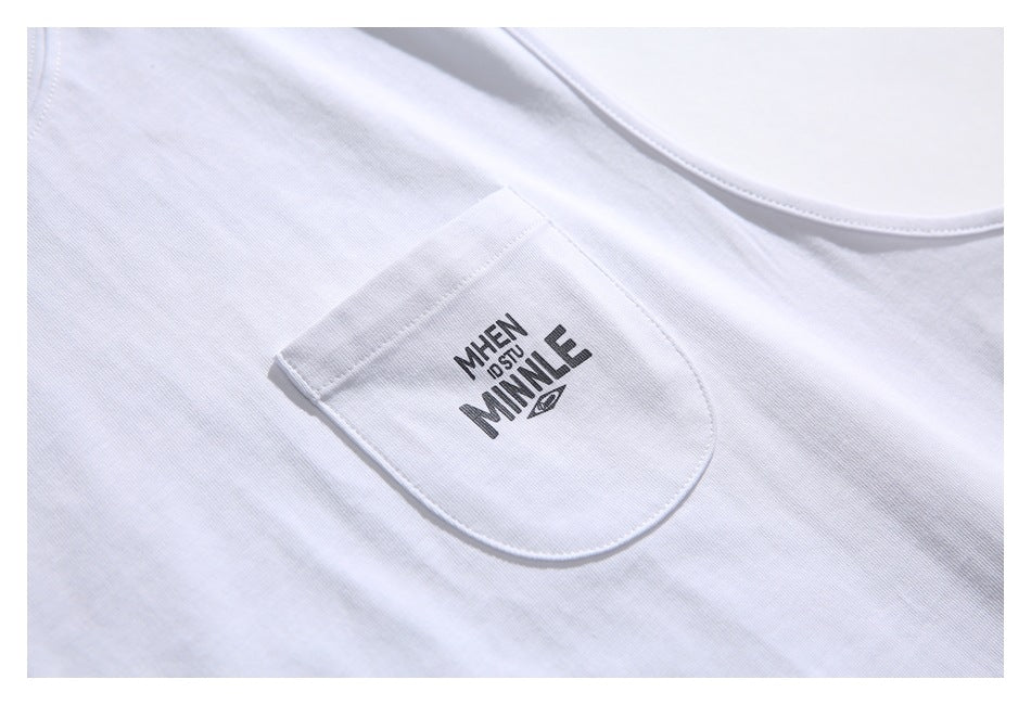 Close-up of the white shirt's rounded chest pocket with a dark printed design.