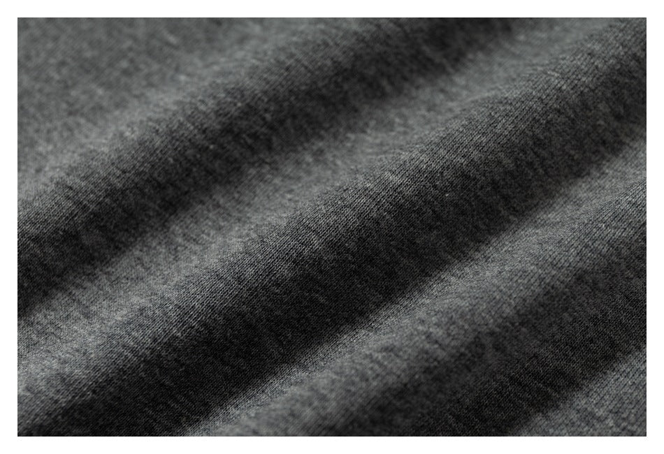 Extreme close-up of the gray garment's knit surface and fabric texture.