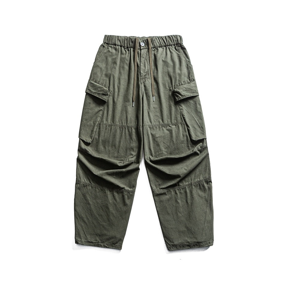 Olive green wide-leg cargo pants with elastic drawstring waist and large side flap pockets, flat front view