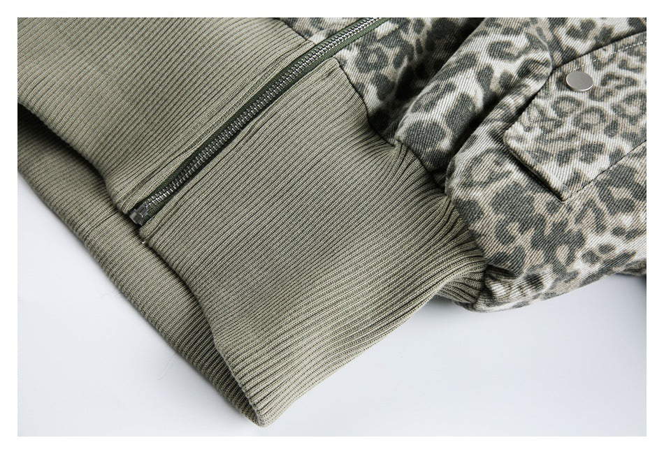 Close-up of the jacket's olive ribbed hem, zipper, and animal-print snap pocket.