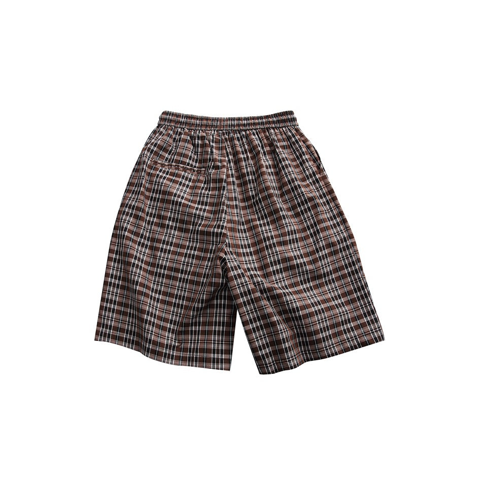 Back view of brown plaid shorts with elastic waistband and a back patch pocket, flat lay