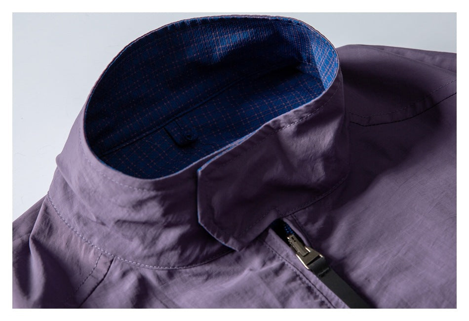Close-up of the jacket's purple stand collar, blue patterned lining, and upper zipper.