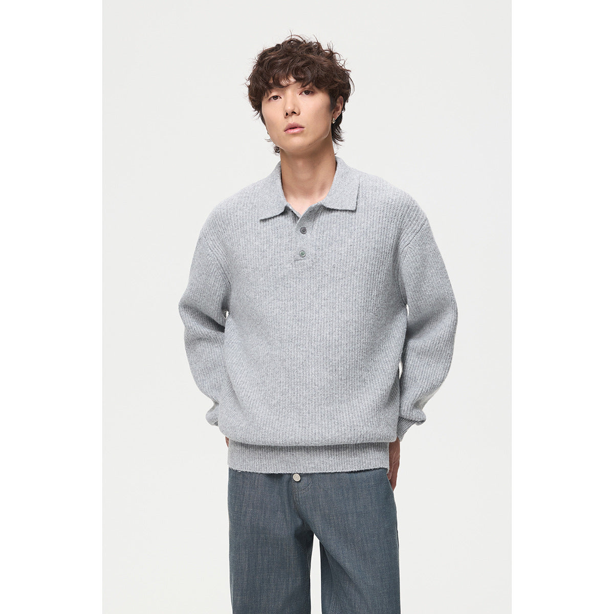 Model wearing a light gray long-sleeve knit polo sweater with a two-button placket, shown from the front.