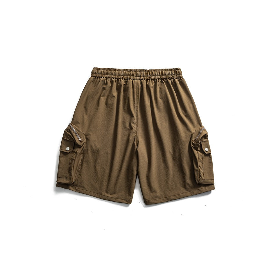 Back view of brown cargo shorts with an elastic waistband and side flap pockets with zippers and snaps.