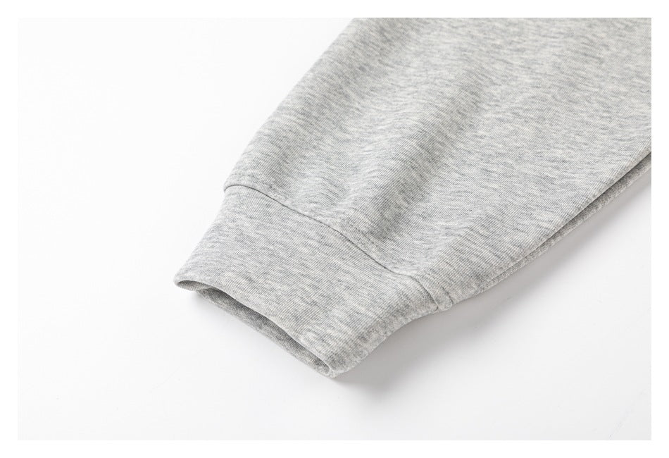 Close-up of the gray marled hoodie sleeve and ribbed cuff.