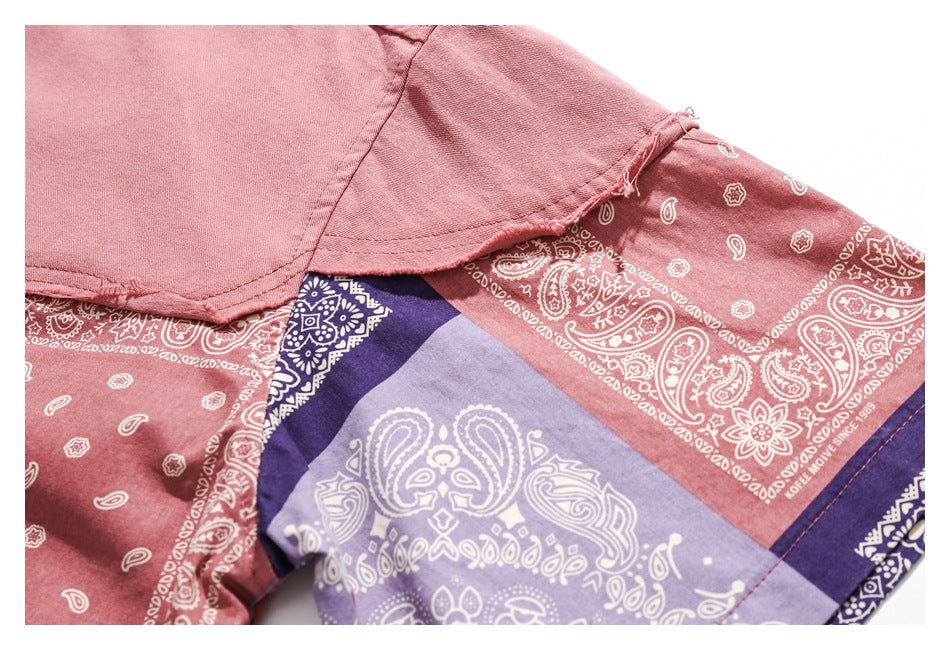 Close-up of the shirt's frayed seam and patchwork sleeve with pink, lavender, and navy bandana prints.