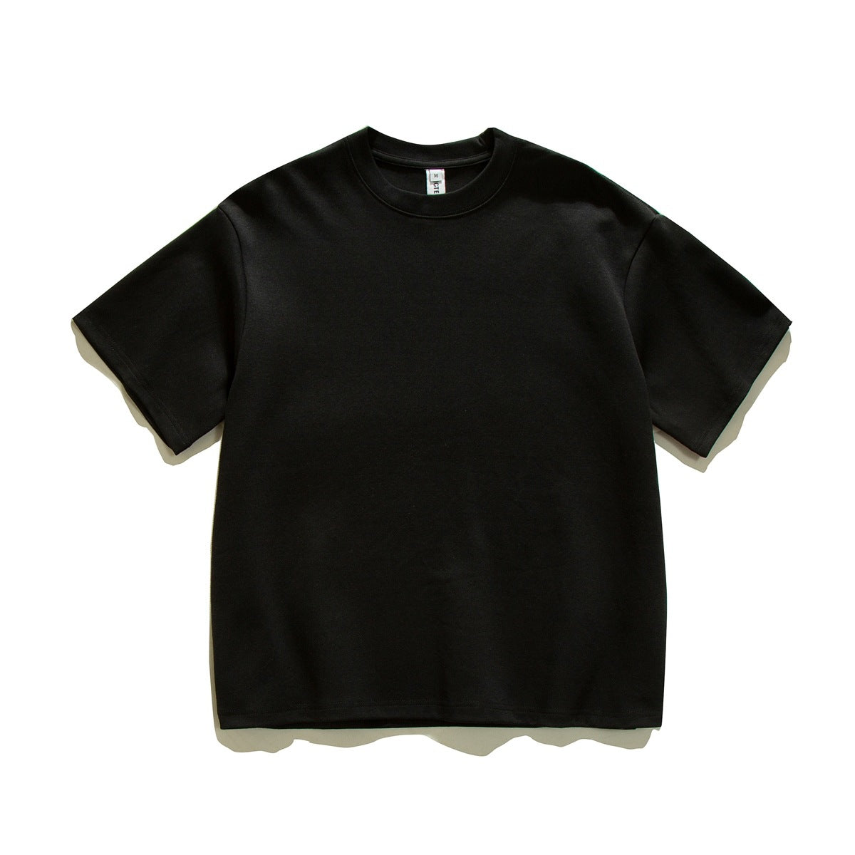 Black short-sleeve crew-neck T-shirt laid flat, front view, plain with dropped shoulders