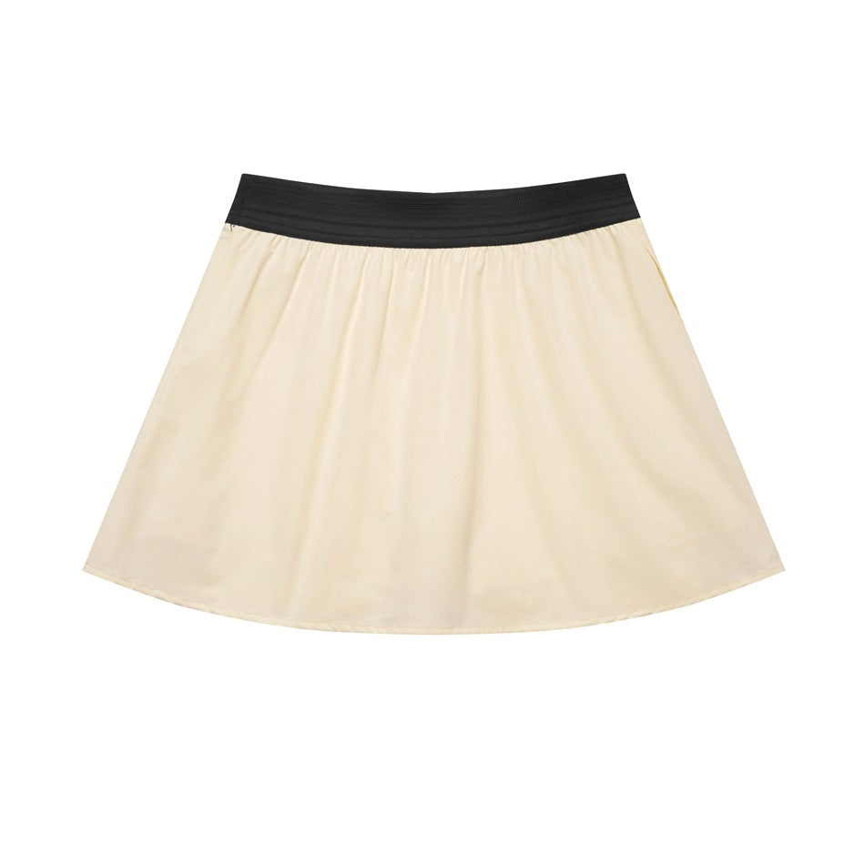 Cream flared athletic skirt with a black wide waistband, shown flat against a white background.