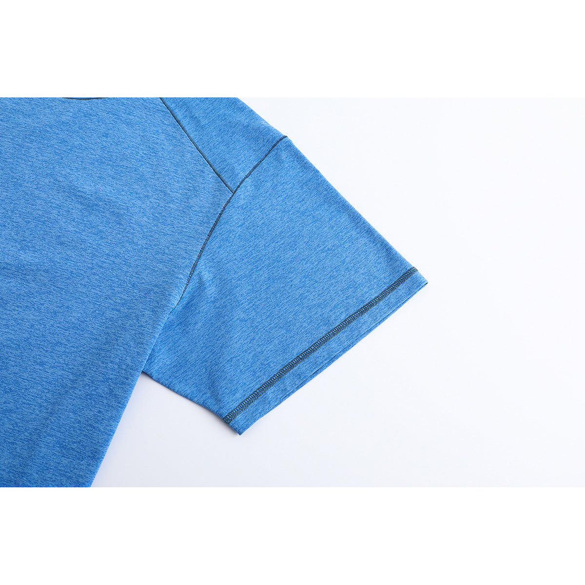 Close-up of a heathered blue T-shirt sleeve showing its seam and stitched hem.