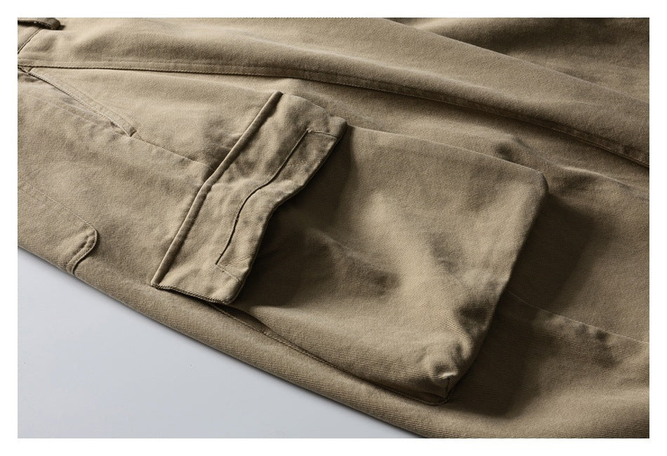 Close-up of a large flap pocket and stitching on tan trousers.
