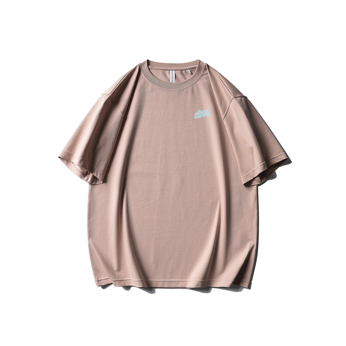 Front view of a dusty pink oversized T-shirt with a small light-blue script logo on the chest.