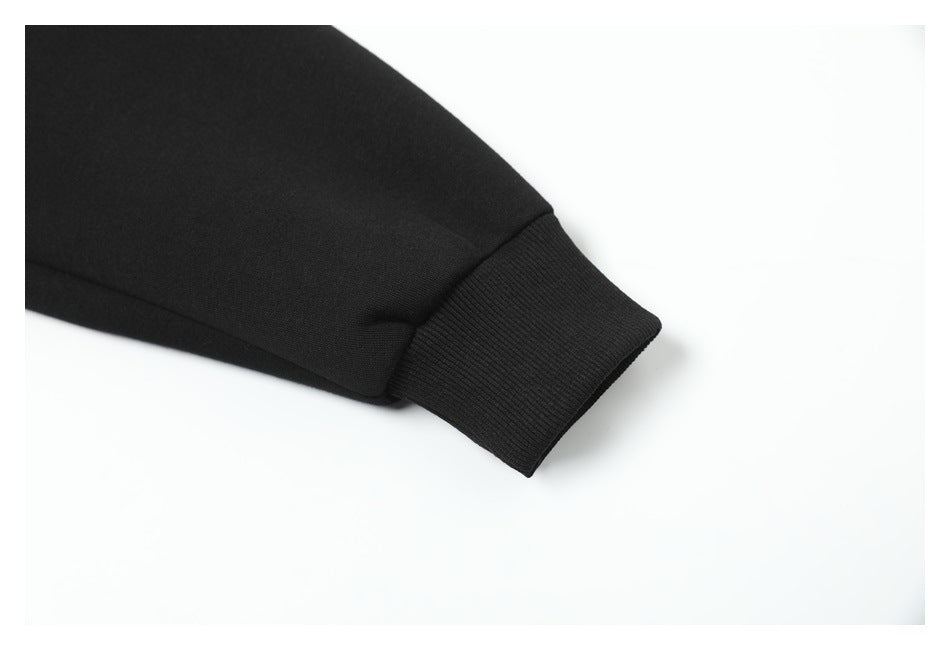 Close-up of a black hoodie sleeve ending in a ribbed cuff.